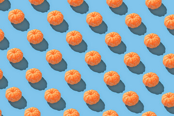 Peeled mandarin repeated seamless pattern on blue backdrop