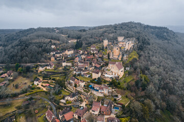 Fototapeta na wymiar Aerial view of an ancient medieval French village and Castelnaud-la-Chapelle Castle on the mountain in France