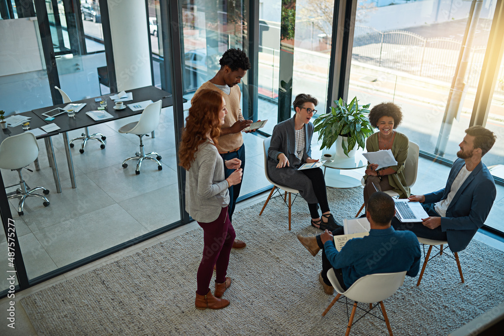 Poster strengthening partnerships through teamwork. shot of a group of creatives having a meeting in a mode