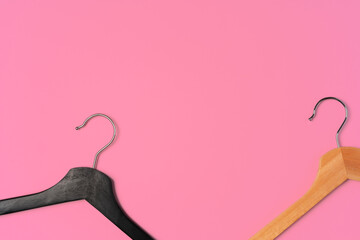 Flat lay composition with empty hangers on pink background