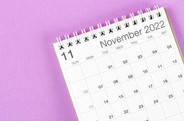 November 2022 desk calendar on light purple background.