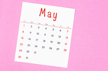 Fototapeta na wymiar May 2022 calendar on pink background with empty space.