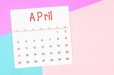 Fototapeta na wymiar April 2022 calendar on multicolored background.