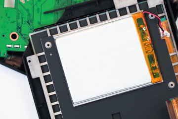 Obraz premium Disassembled equipment, opened microcircuits, battery. Broken electronic book, repair of e-books