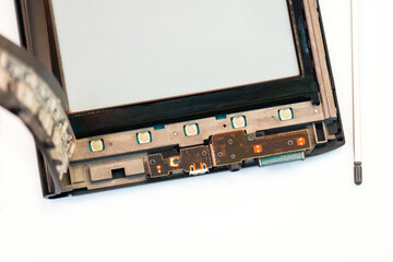 Opened electronic book with stylus, repair of e-book. Disassembled equipment on white background