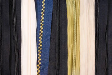 Textile industry,  zipper background. Zippers of different colors for tailoring
