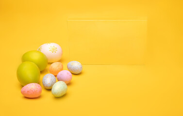 Hand painted easter eggs on a yellow background, horizontal view. Easter decorations, banner, photo with a copy space.