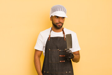 afro cool man feeling sad, upset or angry and looking to the side. butcher concept