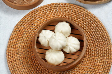 baozi or bapao,bakpao-Chinese steamed buns,served in bamboo steamer.white background	