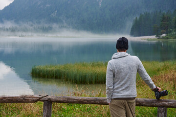 Photographer on Lake Dobbiaco - Dolomites, Italy