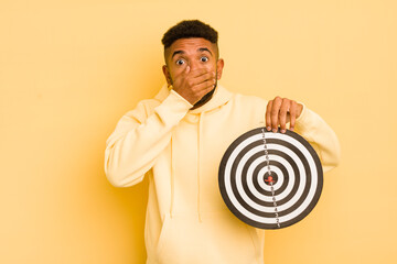 afro cool man covering mouth with hands with a shocked. dart target concept