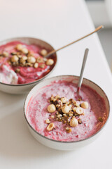 Delicious, healthy breakfast bowl: mix of nuts, seeds, whole grains and yogurt with blended frozen berries. Morning meal rich in vitamins and fiber. Well eating lifestyle. Selective focus. Vertical
