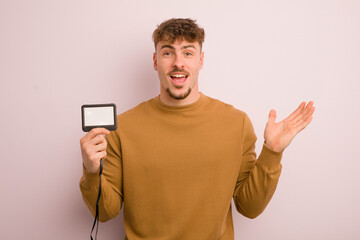 young cool man feeling happy, surprised realizing a solution or idea. vip pass id concept