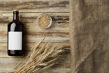A bottle of beer and grain. Top view. Free space for text.