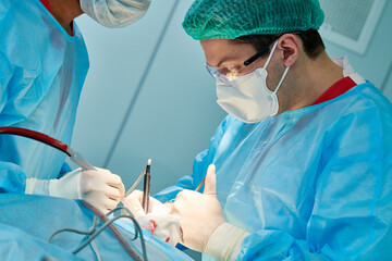 Emergency surgery. Surgeons during surgical intervention in clinic