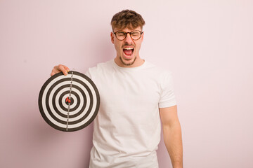 young cool man shouting aggressively, looking very angry. dart target concept