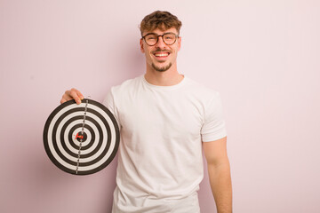 young cool man looking happy and pleasantly surprised. dart target concept