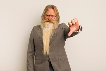 cool senior man feeling cross,showing thumbs down. crazy teacher concept