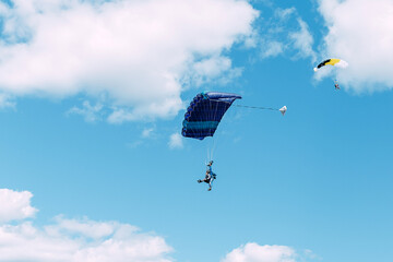 skydiver. sky. clouds. freedom. air. flight. dome. parachute. man in free fall.