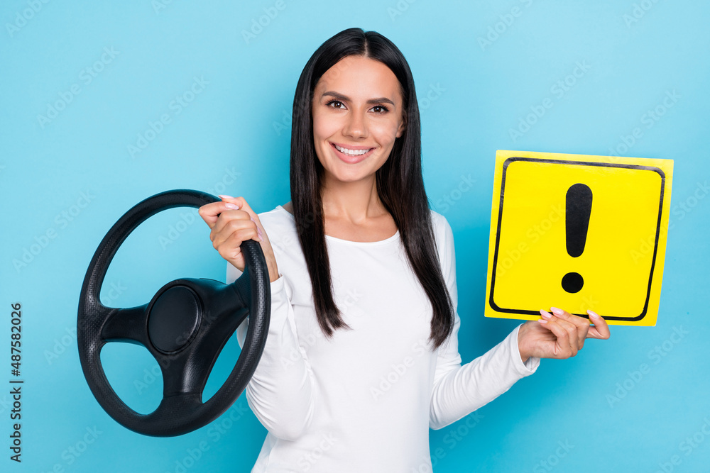 Sticker Photo of young woman hold paper symbol careful transport vehicle automobile isolated over blue color background