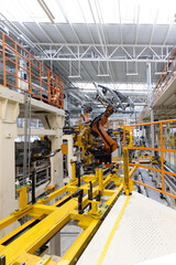 Vertical photo of automobile production line. Welding car body. Modern car assembly plant. Auto industry