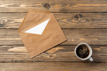 Vintage envelope with empty card, pen on wooden table top view