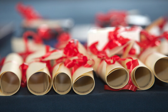 Award rolls made of paper and decorated with red ribbons, prepared for an academic ceremony