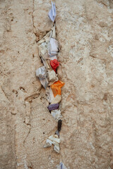 Tiny, folded pieces of paper with written notes addressed to God are crammed into cracks, crevices and crannies of the Western Wall in the Old City of Jerusalem.