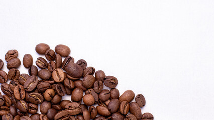 fragrant beans from the coffee tree in medium roast lie on a white background with a place for text