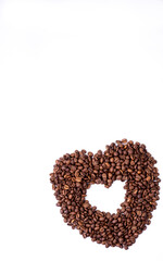heart of brown fragrant coffee beans lie on a white background for text