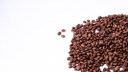 medium rare brown arabica coffee beans lie on a white background for text