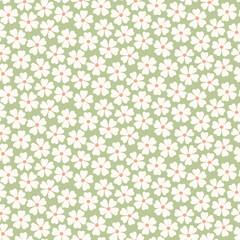 Seamless pattern of abstract white flowers on a green background.