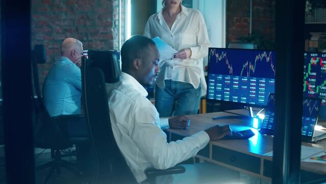 A group of traders working with the stock data in the office