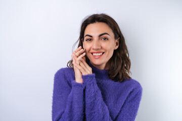 Young woman in a purple soft cozy sweater on the background of cute smiling cheerfully, in high...