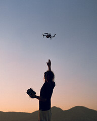 silhouette of a person with a drone