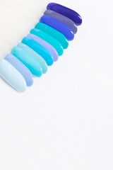 Color palette with blue nail gel polishes for manicure on a white background. Vertical format with copy space