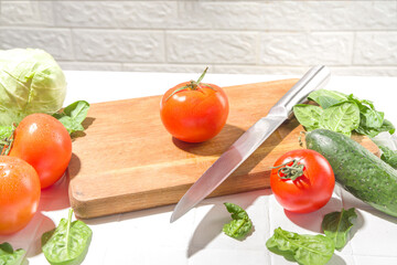 Close-up of cutting slicing fresh tomatoes. Womans hands cut with knife fresh tomato vegetables