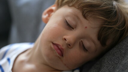 Fototapeta na wymiar Little boy asleep child napping close-up face toddler boy resting