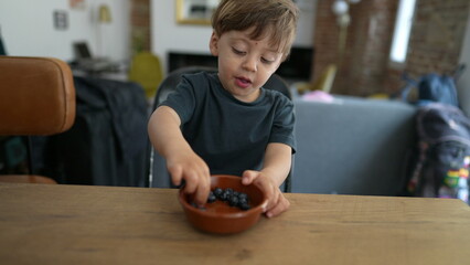 Kid eating healthy blueberry fruit