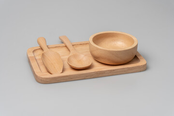 Wooden cups and stacks on wooden trays on a white background.