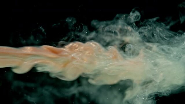 Abstract background video atr with green on a black background. Green line of paint goes down, glitter flies.