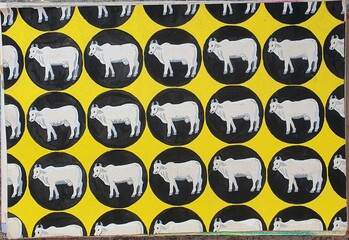 pattern of cows in black circle in yellow background