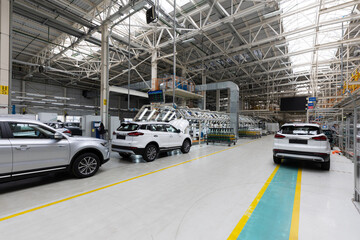 Fototapeta na wymiar Automobile production line. Modern car assembly plant. Interior of a high-tech factory, manufacturing