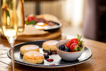 cheesecakes with berries on a plate garnished with jam. healthy breakfast.