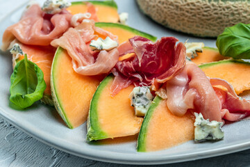 Appetizer, melon with jamon and Basil. Antipasti, Italian food. Restaurant menu, dieting, cookbook recipe top view