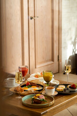 breakfast table with a variety of dishes and drinks