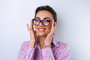 Young woman in a lilac shirt on a white background in glasses for vision cheerful positive in a...