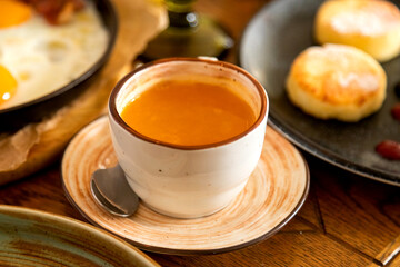 breakfast table with a variety of dishes and drinks
