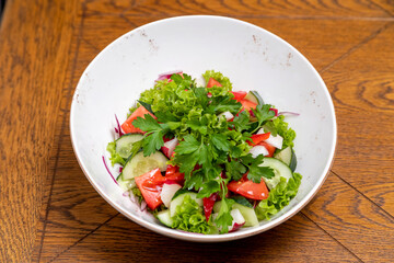 fresh salad served with a glass of wine. served table