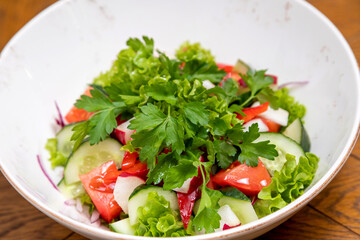 fresh salad served with a glass of wine. served table